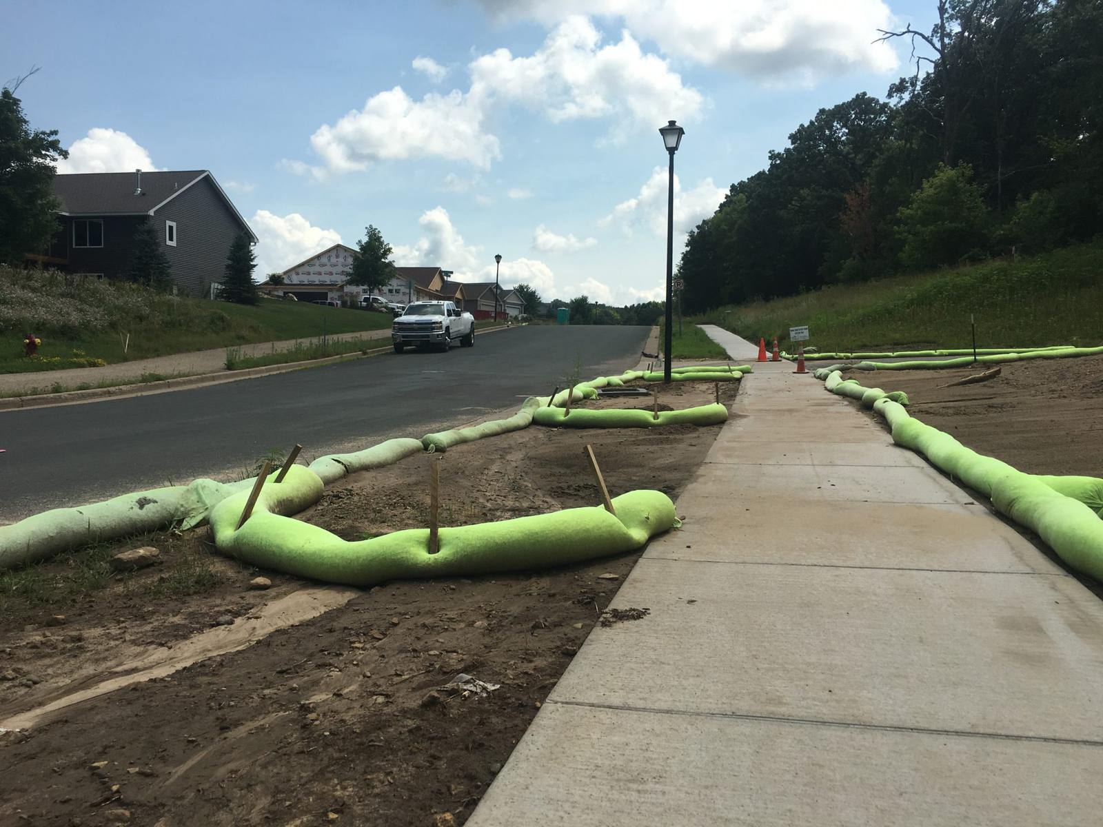 AGgrow Wattle filter sock lining a roadside sidewalk