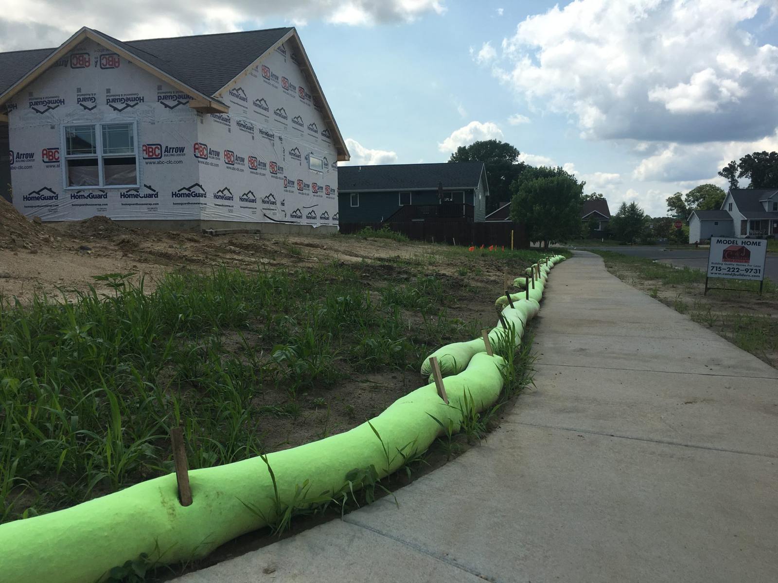 AGgrow Wattle installed along a sidewalk at a home construction site