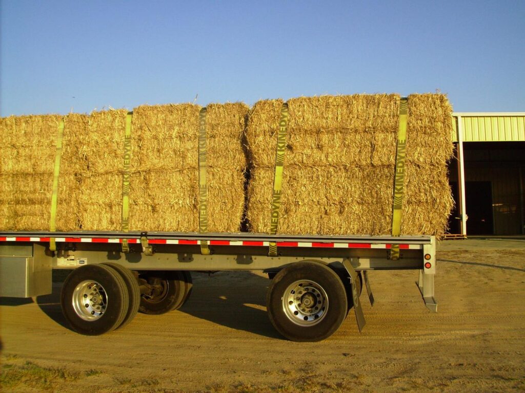 Round miscanthus bales loaded on a flatbed truck